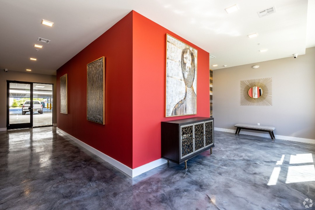 Fourth floor hallway with seating area and ornate gold mirror