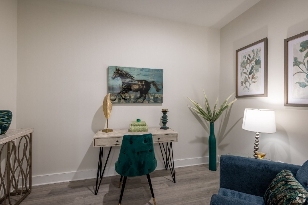 Home office nook with desk and seating area in a 127 The View apartment